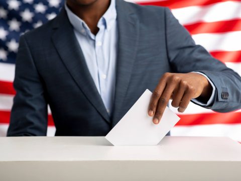 african-american-man-holds-envelope-in-hand-above-2022-12-16-07-55-47-utc.jpg